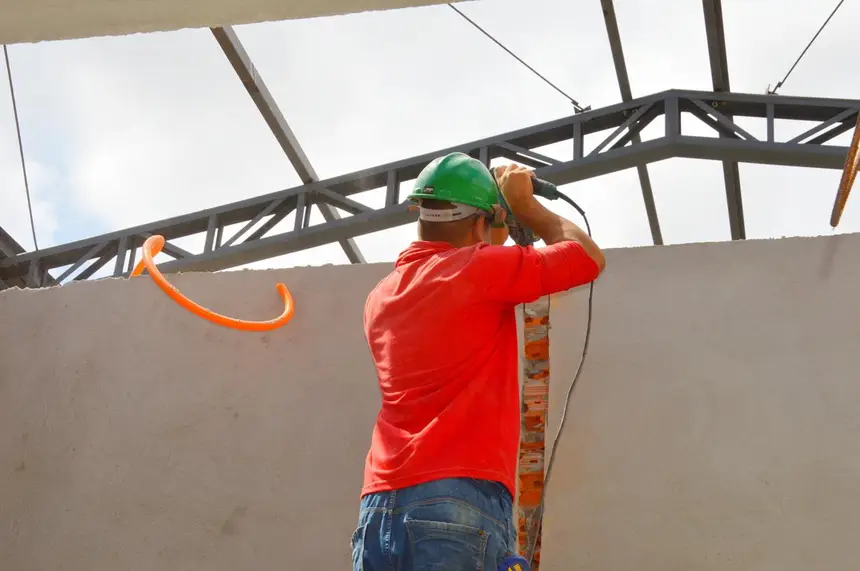 Operários trabalham na instalação da rede elétrtica