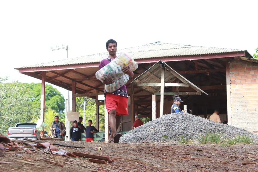 Indígenas ajudam carregar os kits de alimentos às embarcações na Aldeia do Manga