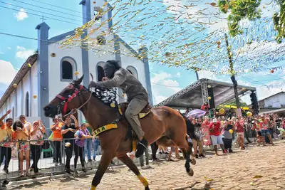 notícia: Festa de São Tiago: público se diverte ao atirar bagaços de laranja na passagem do ‘Bobo Velho’