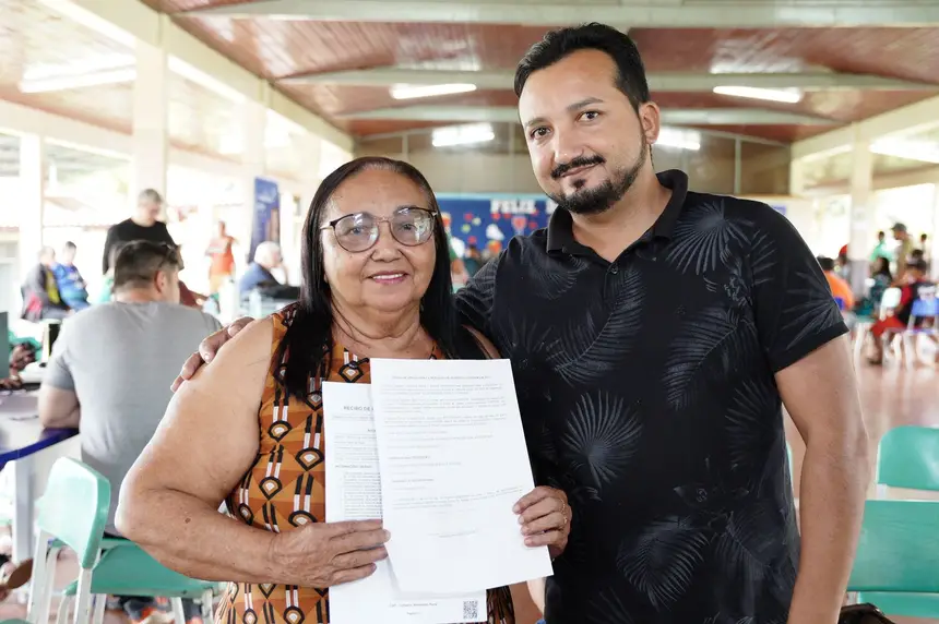 Agricultora Maria de Nazaréde Souza ao ladodoo.fiilho coomemorra emissãoo d Car e inscrição no Floresta+